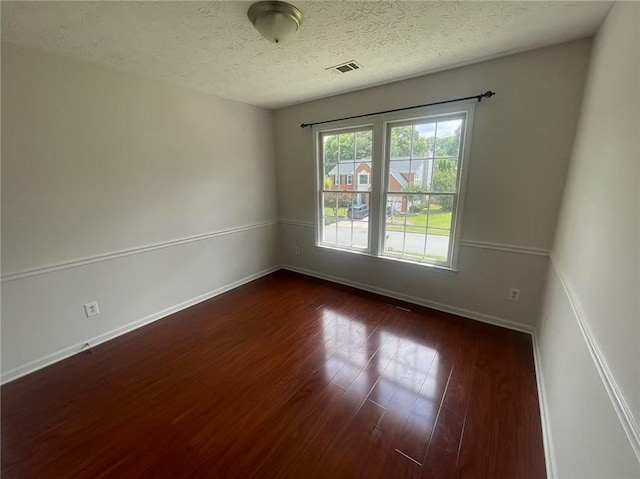 2994 Abbotts Oak Way, Duluth, GA 30097 - unfurnished room with dark wood-style flooring and a textured ceiling