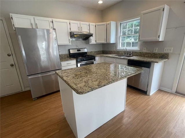 2994 Abbotts Oak Way, Duluth, GA 30097 - kitchen featuring stainless steel appliances, under cabinet range hood, wood finished floors, stone countertops, and white cabinetry