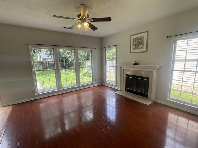 2994 Abbotts Oak Way, Duluth, GA 30097 - unfurnished living room featuring a glass covered fireplace, hardwood / wood-style flooring, ceiling fan, and plenty of natural light