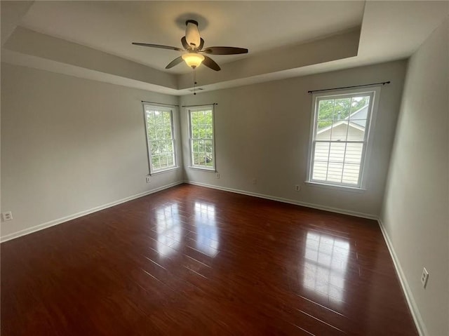 2994 Abbotts Oak Way, Duluth, GA 30097 - spare room featuring a raised ceiling, plenty of natural light, dark wood finished floors, and ceiling fan