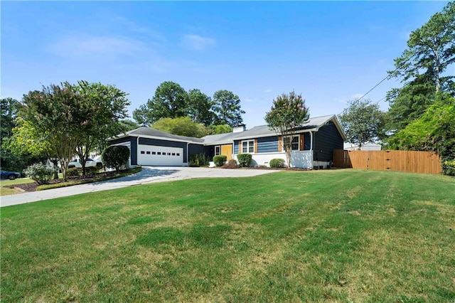 ranch-style house featuring a front yard, an attached garage, fence, and concrete driveway