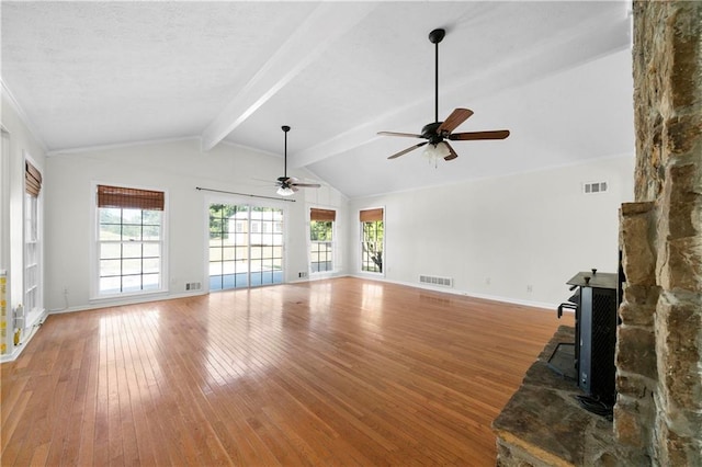 unfurnished living room featuring ceiling fan, wood-type flooring, and vaulted ceiling with beams