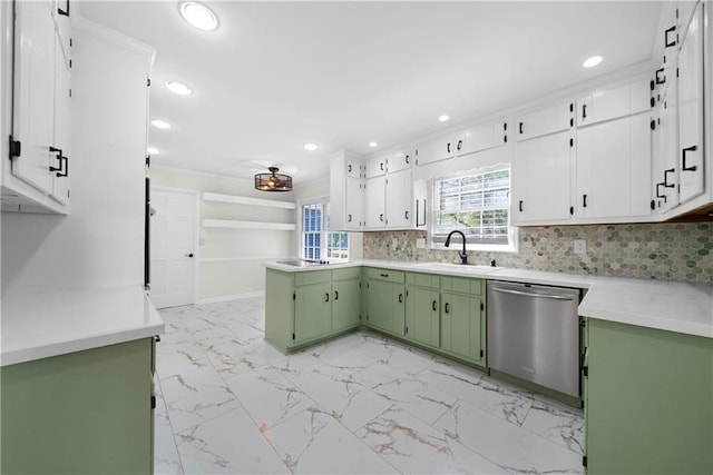 kitchen featuring tasteful backsplash, green cabinetry, dishwasher, a sink, and marble finish floor