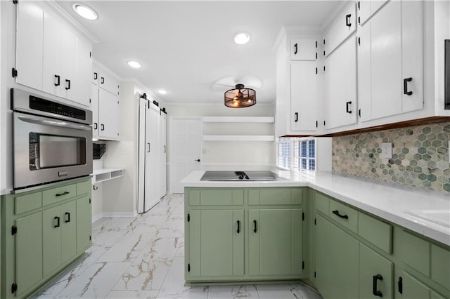 kitchen with stainless steel oven, light countertops, marble finish floor, and a barn door