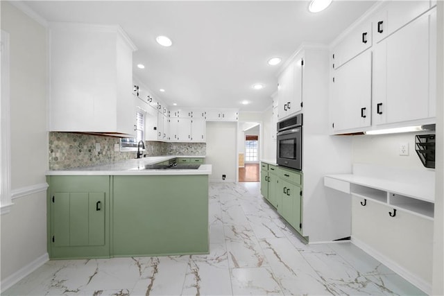 kitchen featuring green cabinets, white cabinets, oven, tasteful backsplash, and ornamental molding