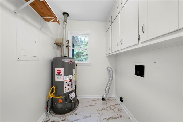 clothes washing area with marble finish floor, water heater, baseboards, and cabinet space