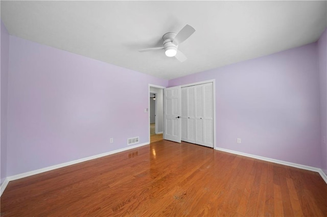 unfurnished bedroom with a closet, ceiling fan, and wood-type flooring