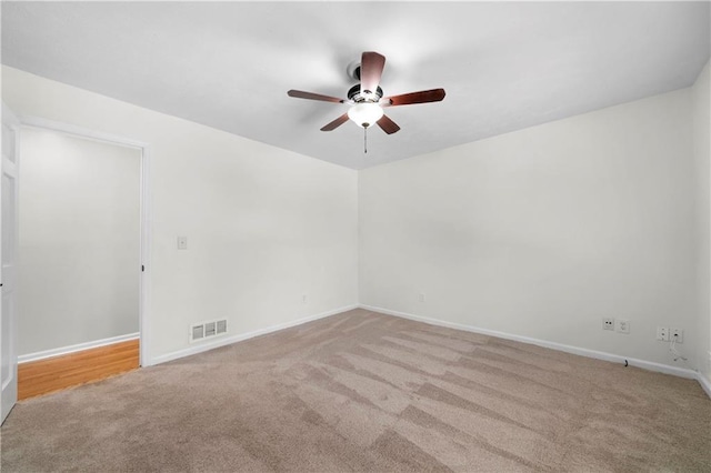 unfurnished room featuring visible vents, baseboards, a ceiling fan, and carpet floors