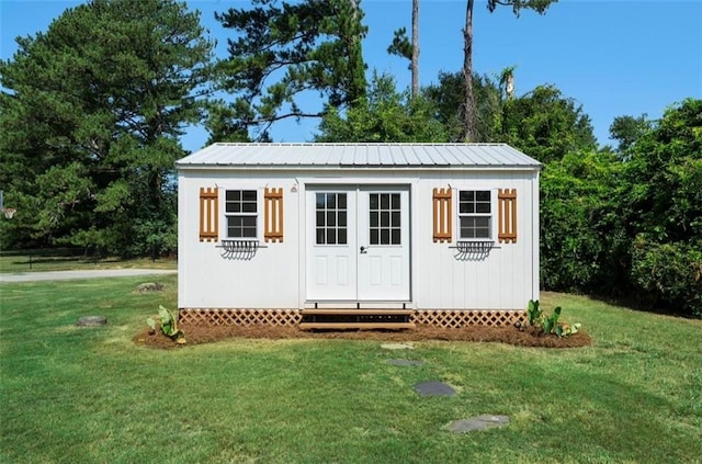 view of outdoor structure with a lawn