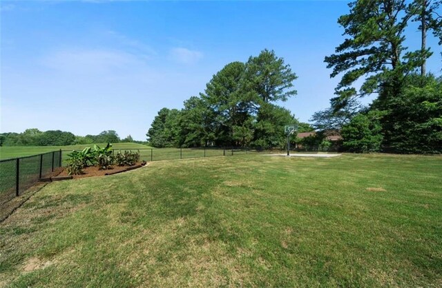 view of yard featuring a rural view and fence