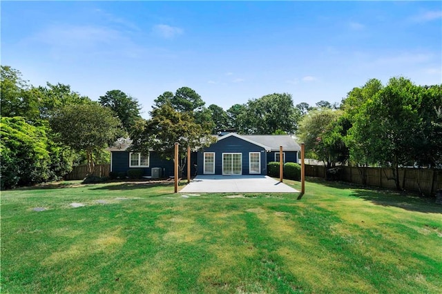 back of house with a patio area and a yard