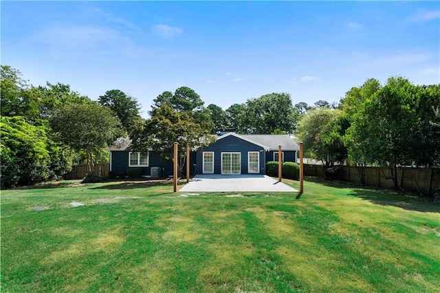 back of property featuring a yard, a fenced backyard, a patio, and central air condition unit