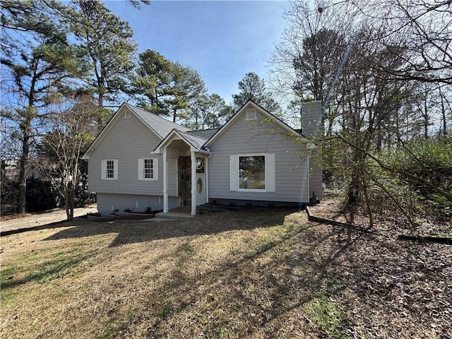 single story home with a chimney and a front lawn