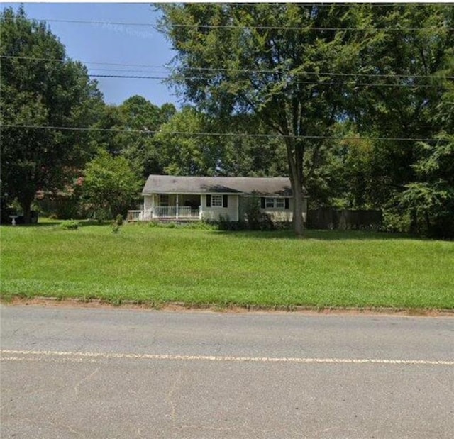 view of front of home with covered porch and a front yard