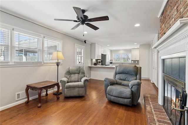 sitting room featuring recessed lighting, a fireplace, baseboards, and wood finished floors