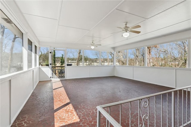 unfurnished sunroom with a ceiling fan