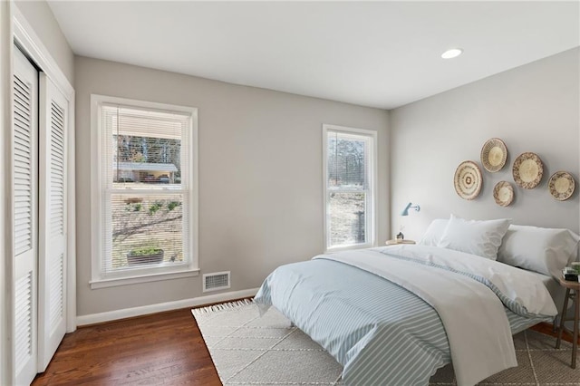 bedroom featuring recessed lighting, a closet, visible vents, wood finished floors, and baseboards