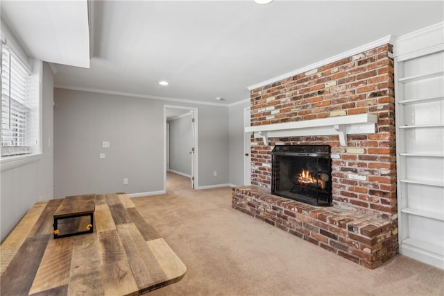 living room featuring baseboards, crown molding, carpet floors, a fireplace, and recessed lighting