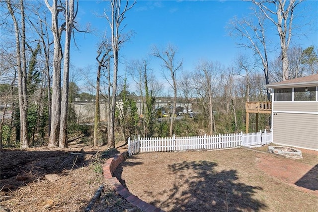 view of yard with fence and a sunroom