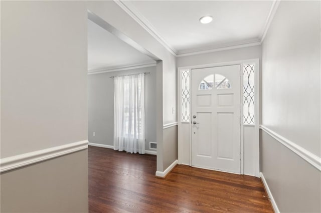 foyer entrance with baseboards, wood finished floors, and crown molding