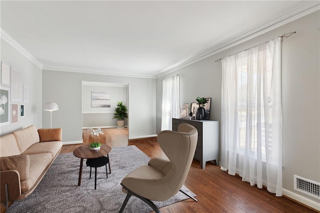 living room with plenty of natural light, wood finished floors, and visible vents