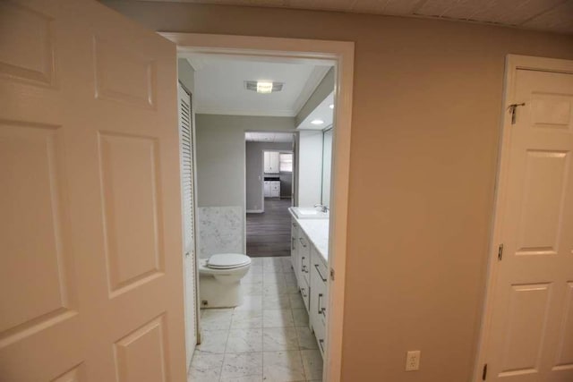 bathroom with vanity, toilet, and visible vents