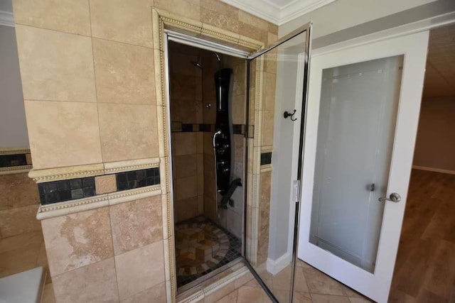 bathroom with tiled shower and ornamental molding