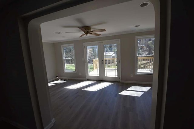 empty room featuring french doors, wood finished floors, baseboards, and ornamental molding