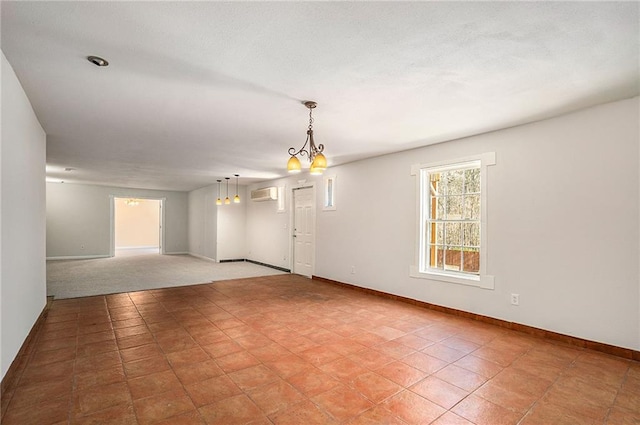 unfurnished room with a wall mounted AC, light tile patterned floors, and a chandelier