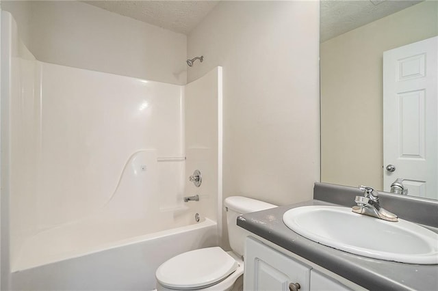 full bathroom featuring vanity, toilet, washtub / shower combination, and a textured ceiling