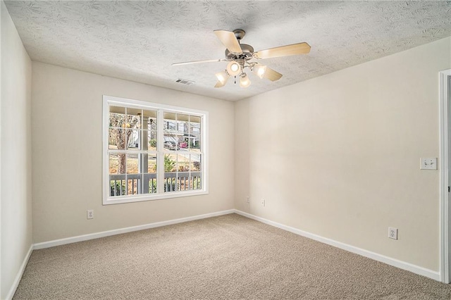 carpeted spare room with ceiling fan and a textured ceiling