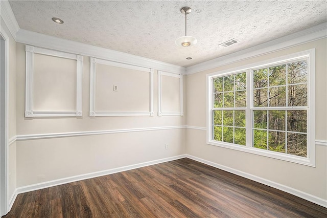 empty room with a textured ceiling and dark hardwood / wood-style floors