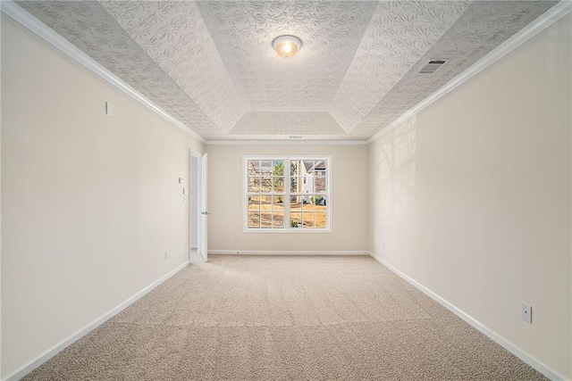 spare room with carpet, a textured ceiling, a tray ceiling, and crown molding