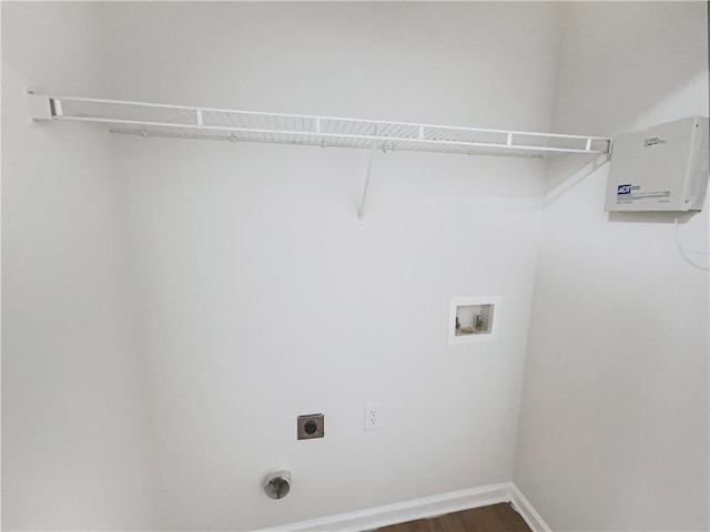 clothes washing area featuring laundry area, baseboards, dark wood-style floors, washer hookup, and electric dryer hookup