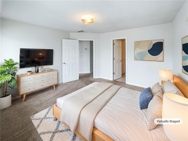 carpeted bedroom featuring baseboards and visible vents