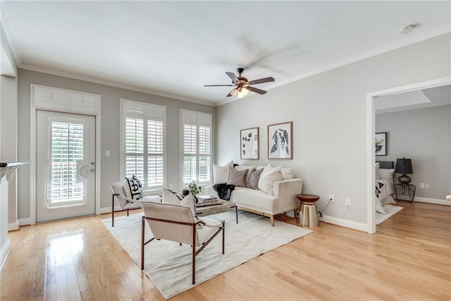 living room featuring ceiling fan, light hardwood / wood-style floors, and ornamental molding