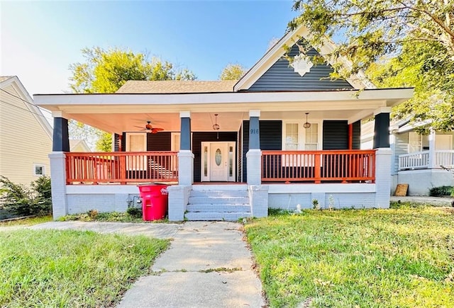 bungalow featuring a front lawn, ceiling fan, and covered porch