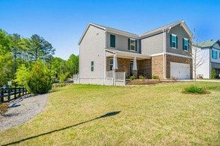 view of front of home featuring an attached garage and a front lawn