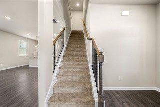 staircase with recessed lighting, baseboards, and wood finished floors