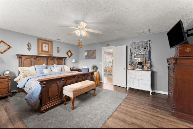 bedroom featuring a textured ceiling, ceiling fan, and hardwood / wood-style floors