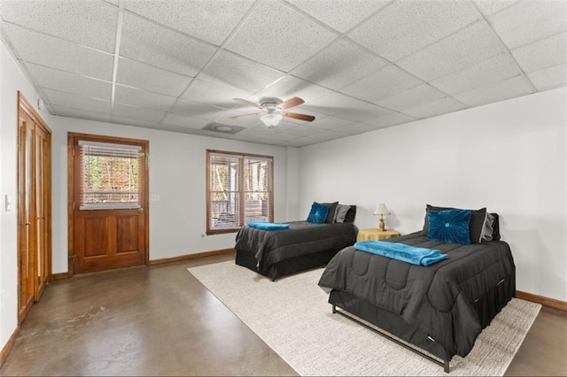 bedroom with a drop ceiling and ceiling fan