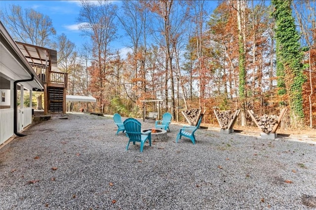 view of yard featuring a fire pit and a wooden deck