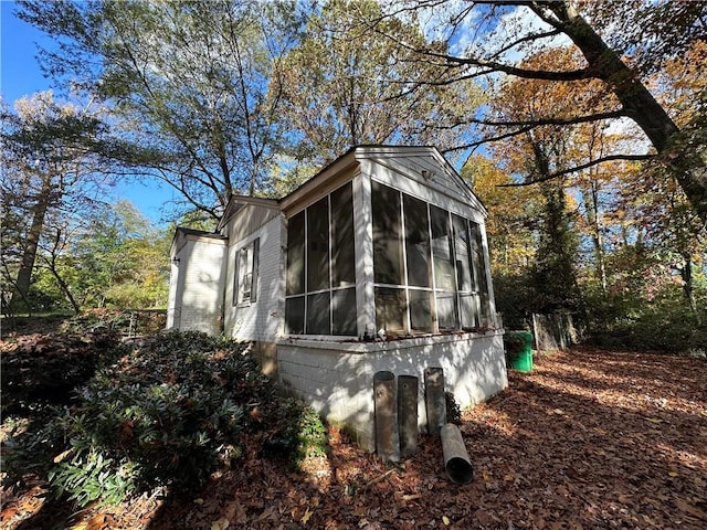 view of side of property with a sunroom