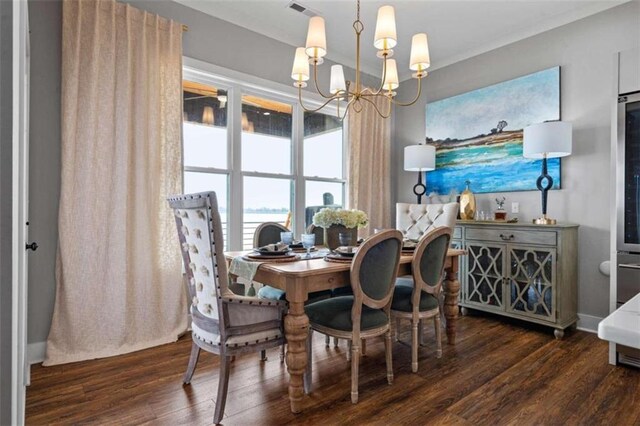 dining space with an inviting chandelier and dark hardwood / wood-style flooring