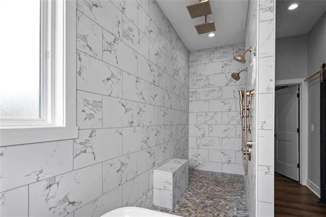 bathroom featuring tiled shower and hardwood / wood-style floors