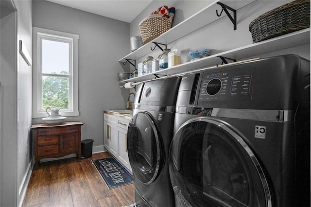 washroom with cabinets, washer and dryer, sink, and dark hardwood / wood-style floors