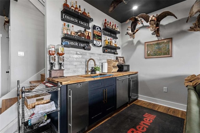 bar with dishwasher, sink, wooden counters, dark hardwood / wood-style flooring, and fridge