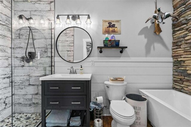 full bathroom featuring vanity, toilet, and separate shower and tub