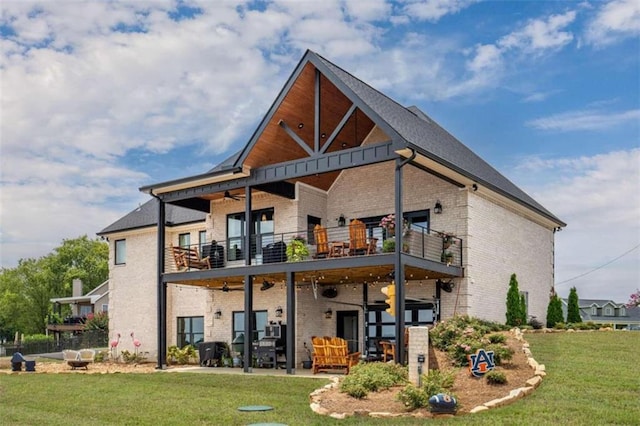 exterior space featuring a patio, a balcony, a front yard, and ceiling fan