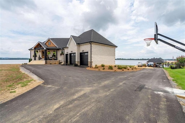 exterior space with a porch and a water view